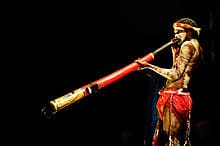 An Aboriginal man playing the didgeridoo